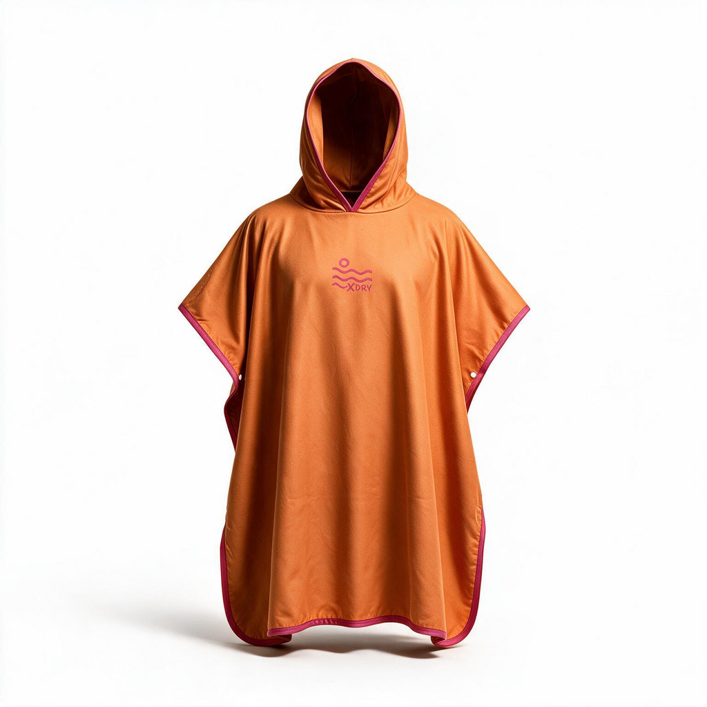 An orange hooded poncho with pink trim and a small pink wave logo on the chest, displayed on a clean white background.