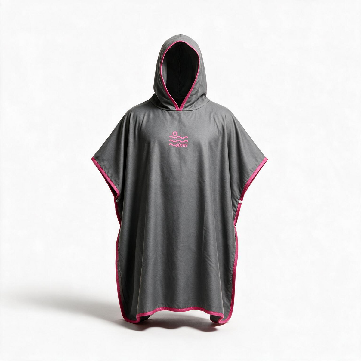 A dark gray hooded poncho with bright pink trim and a small pink wave logo on the chest, displayed on a white studio background.