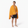 Model wearing golden-yellow towel