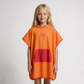 Orange and red poncho on blonde girl