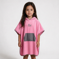 Pink poncho on dark-haired girl