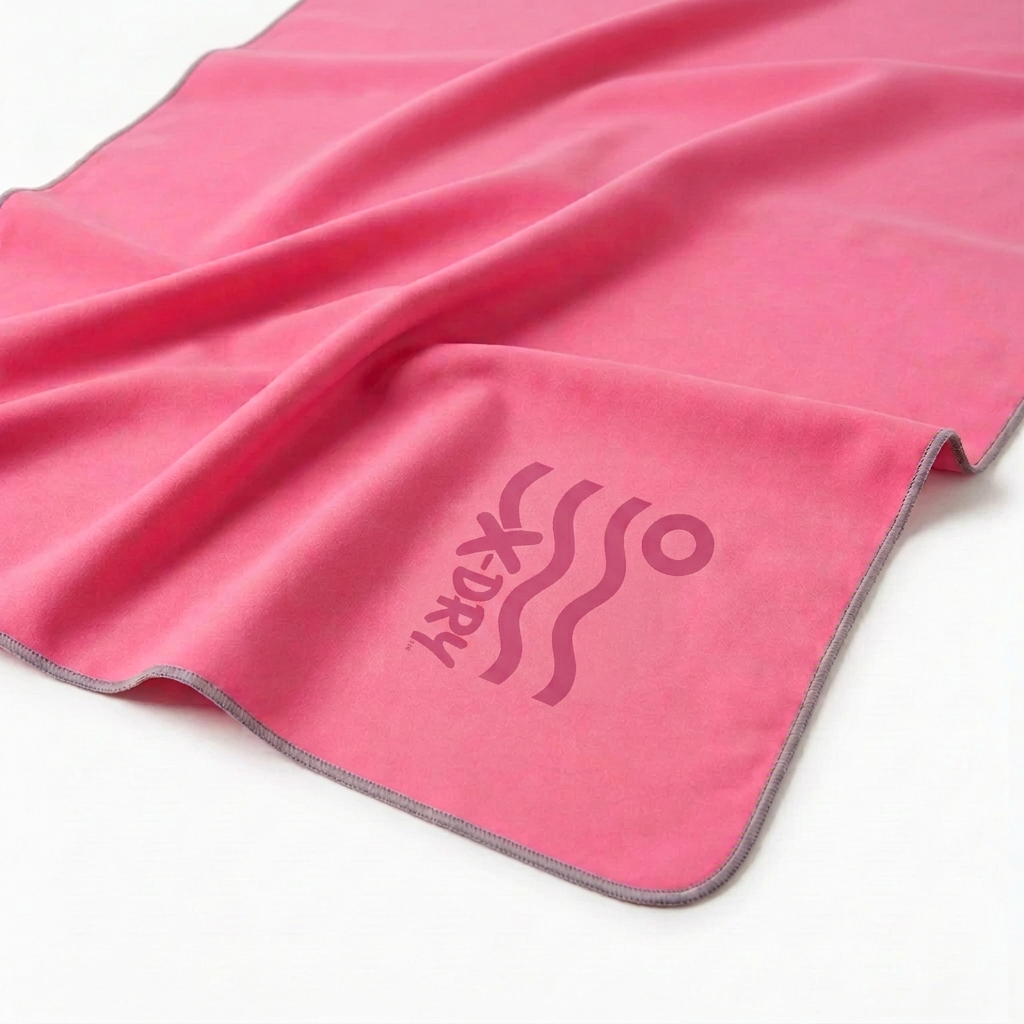 Pink X-Dry towel with logo rotated 90 degrees clockwise